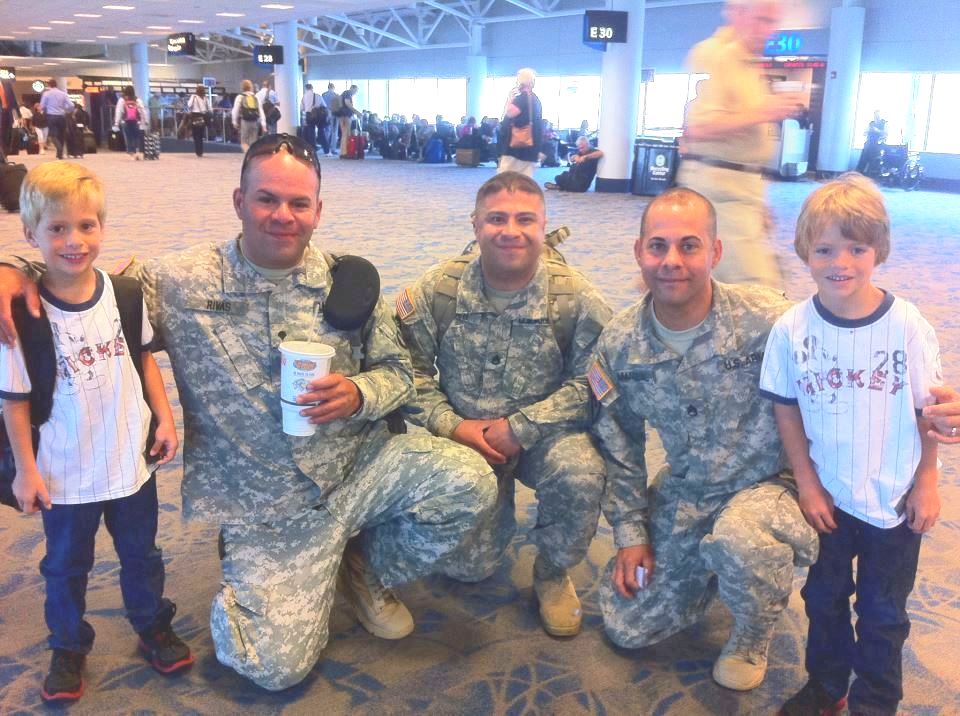 Stars for our troops photo. Armed service men with kids posing for picture