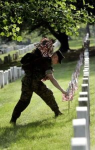 flags are placed in front of graves to honor fallen soldiers who will be remembered on Memorial Day May 31, 2004.