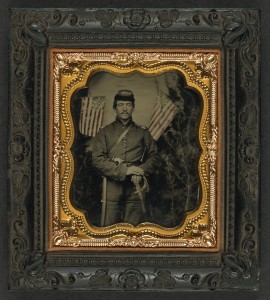 A Union soldier poses with flags