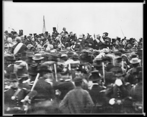 With a flag behind him, Lincoln, minus his stovepipe hat, gives the Gettysburg Address.