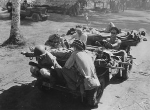 In New Guinea during WWII, wounded men are transported on a Jeep. (Library of Congress)