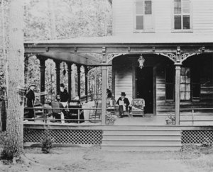 General Grant reads on the porch of the Adirondack cabin where he died. (Library of Congress)