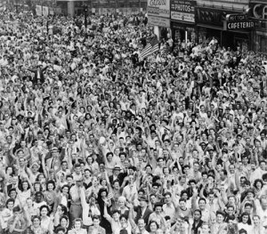 On V-J Day, American flags dot a jubilant crowd in Times Square, New York City. (Library of Congress)
