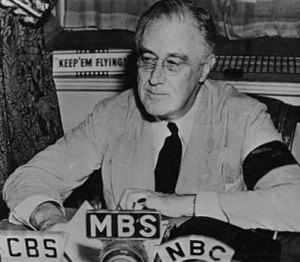 FDR, wearing an armband to mourn his mother, addresses Americans via the radio on Nazi encroachments on U.S. shipping