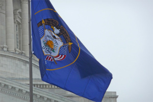 The state capitol backs up the Utah flag. (State of Utah image)