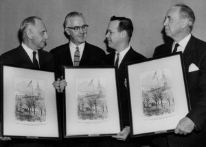 In 1961, Kansas officials hold engravings of President Lincoln's raising of the 34-star flag to mark Kansas' entry into the Union in 1861. (Photo from Kansas Memory)