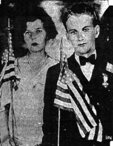 Mary McGonigal and Robert Sullivan each hold an American flag.