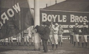 Player-Manager Jimmie Collins of the Boston Americans raises the first championship flag on Opening Day of 1904