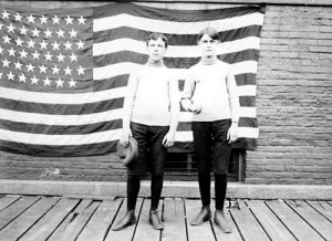Young ballplayers pose before an American flag