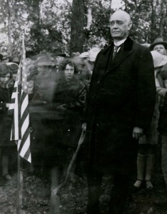 Austin Peay next to an American flag in 1925