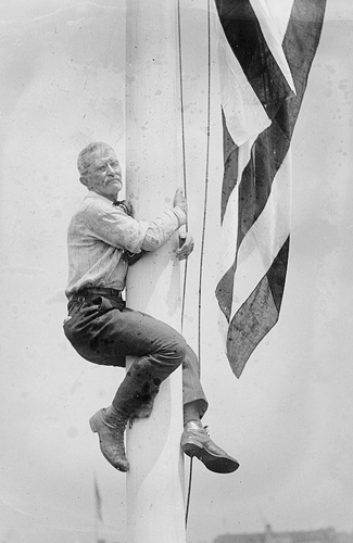 Circa 1920, a man named Edward Flagg shows his love for the American flag by hugging a flagpole. (Library of Congress)
