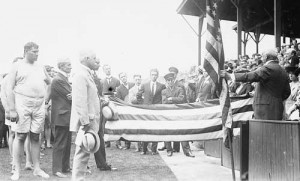 Members and officials of the U.S. Olympic team in Sweden in 1912 accept an American flag. (Library of Congress)