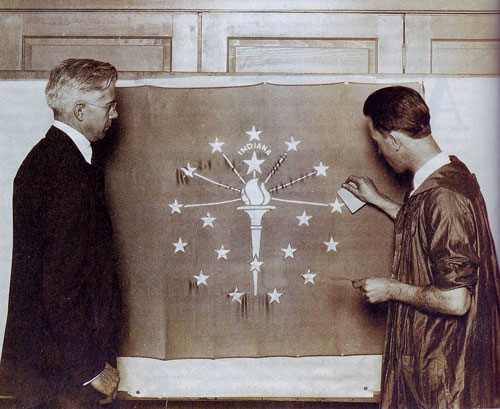 Paul Hadley looks on as an artist applies gold leaf to the state flag. (Mooresville Public Library)