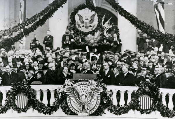 Surrounded by patriotic images, FDR takes his oath.