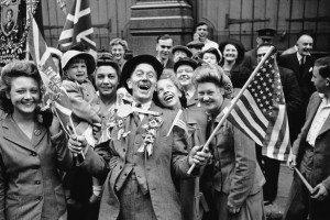 Jubilant British citizens wave flags on V-E Day.