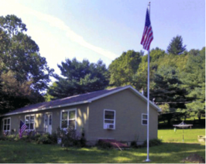 Easy order flag pole outside of a home with an American Flag on it