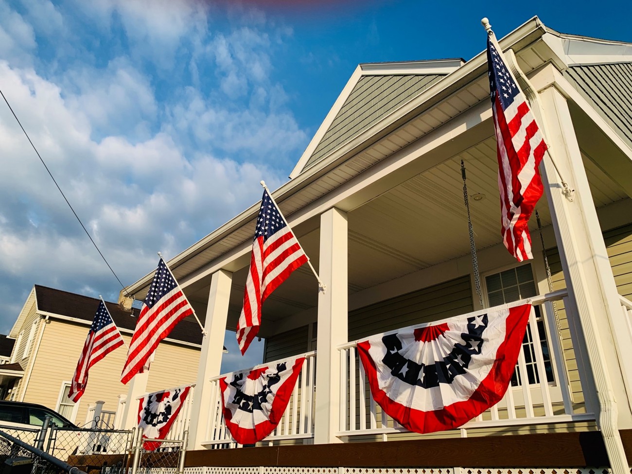Porch decorated with patriotic pleated fans and American flags