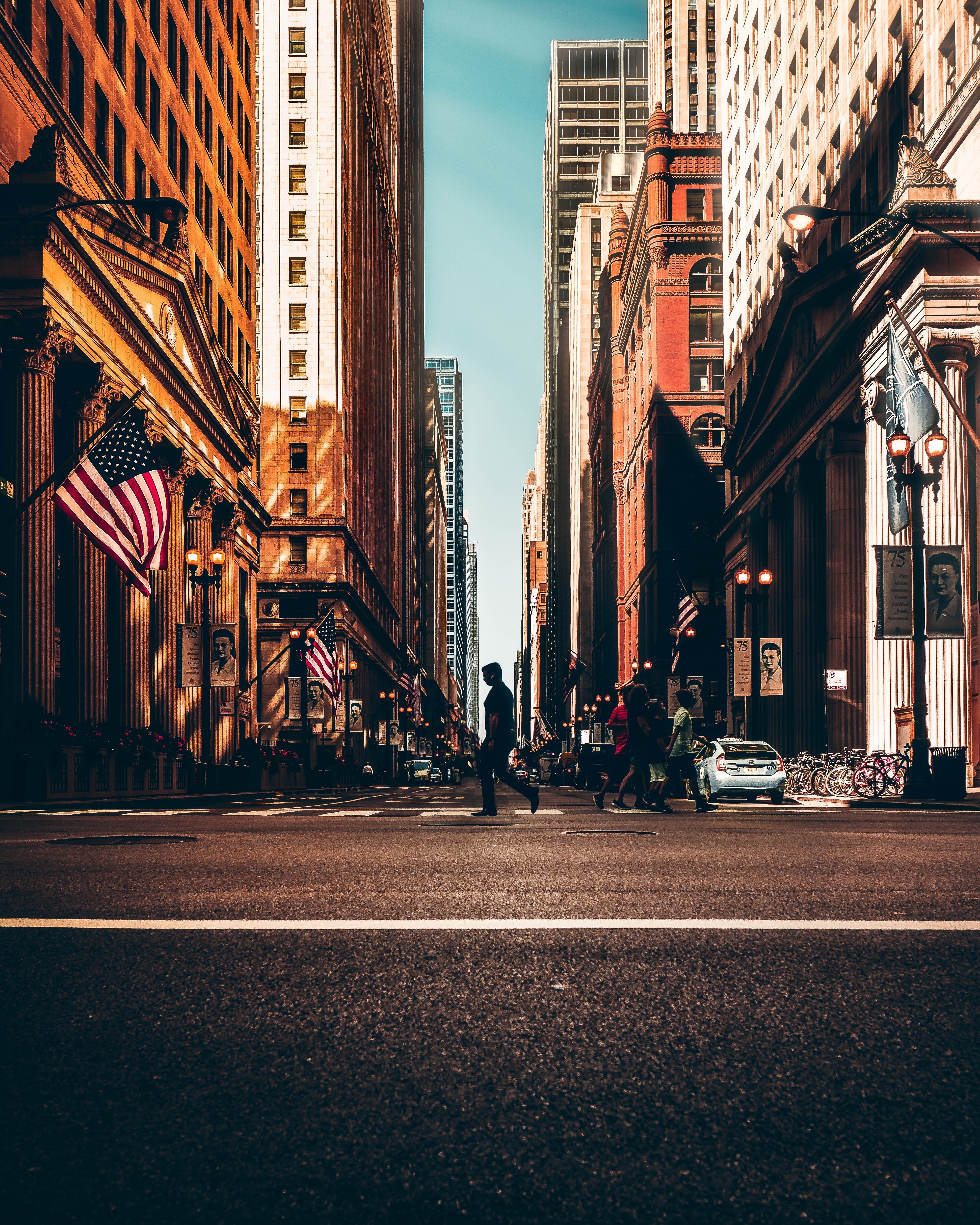 Empty city street with American Flag on Building