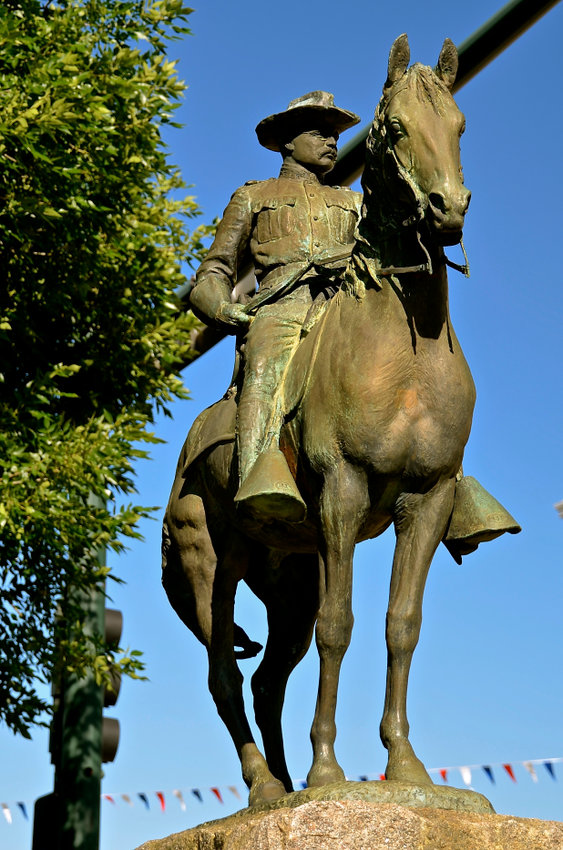 A statue of President Theodore Roosevelt on horseback is displayed against the blue sky at the city park in Mandan ND. 