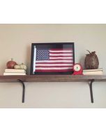 Framed American flag on shelf