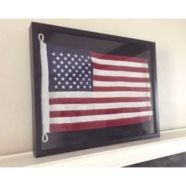 Framed American flag on shelf